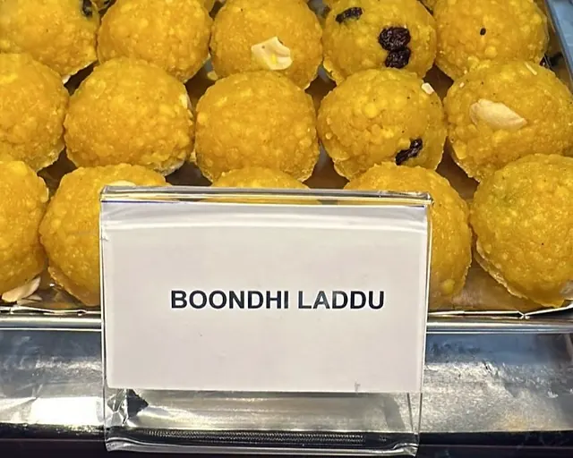 Boondi laddus on the Annapoorna counter with a printed “Boondhi Laddu” label