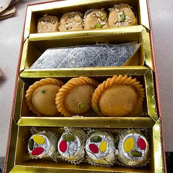 Gold Four-Tier Gift Box — gold four-tier gift box with assorted sweets
