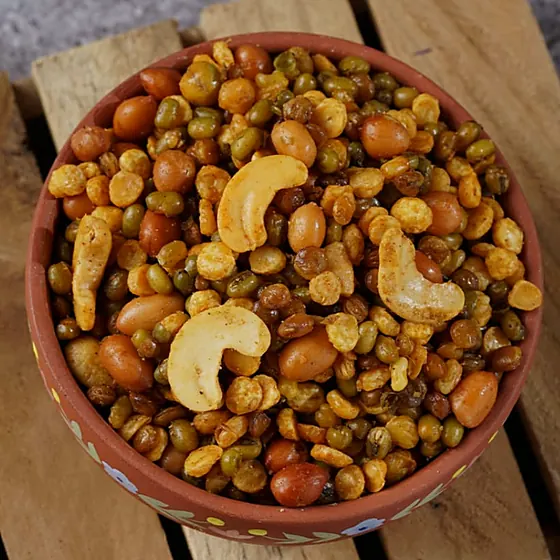 Nut & Lentil Mixture — lentils, peanuts and cashews mixture in a clay bowl