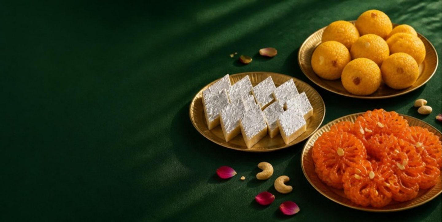 Boondi laddu, kaju katli and jangiri arranged on brass plates